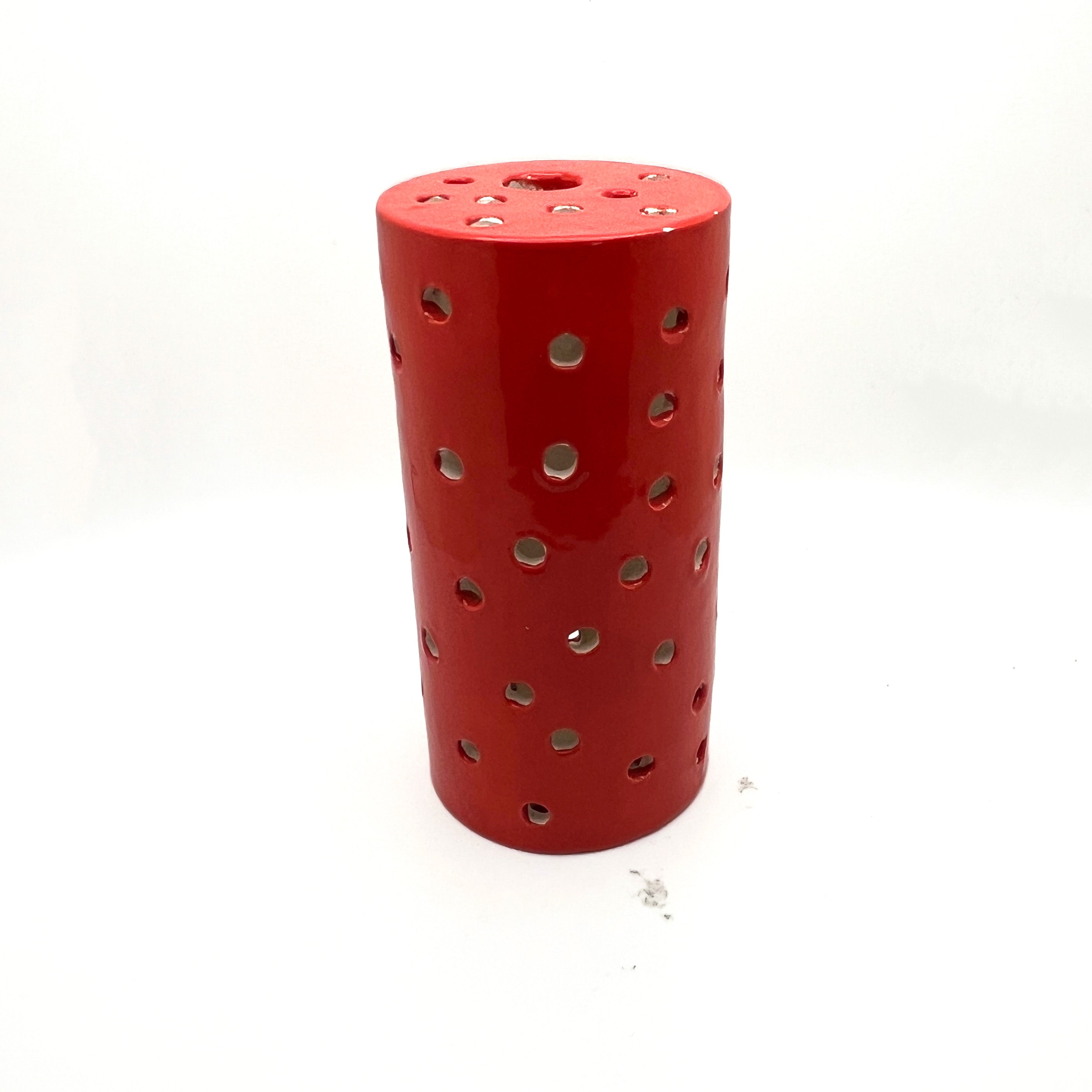 Red Cylinder, circle cut outs by Lynne Berman